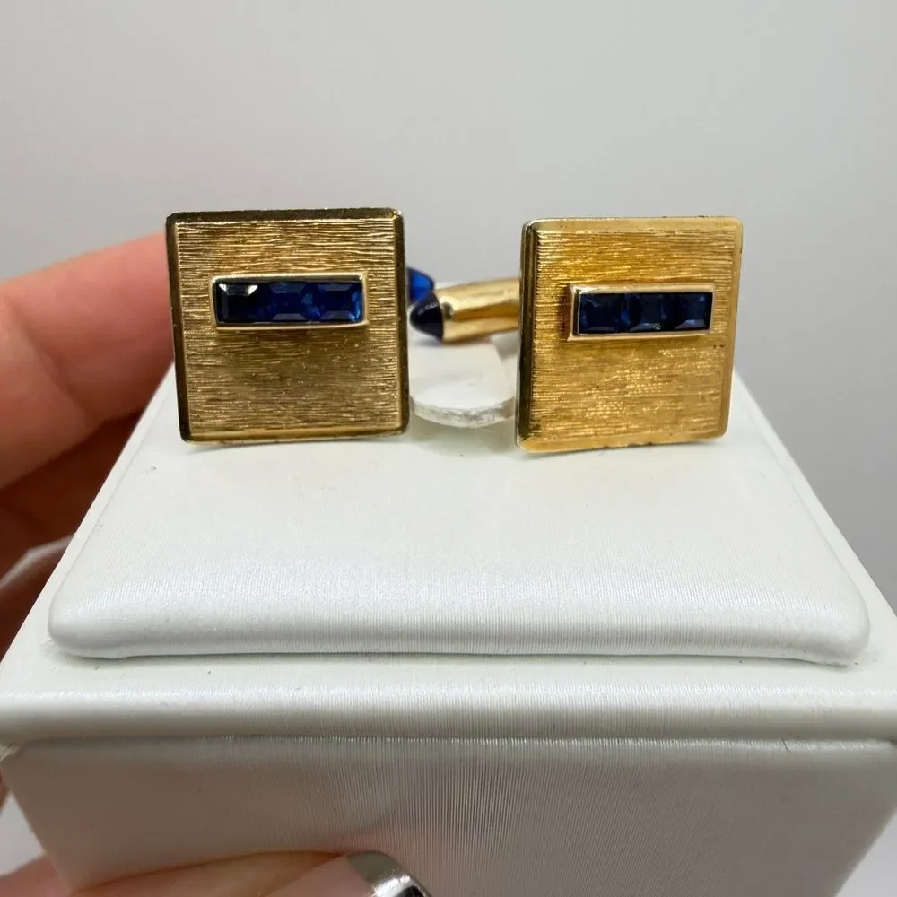 Vintage Krementz Gold tone cuff likes with princess cut blue rhinestone accents!